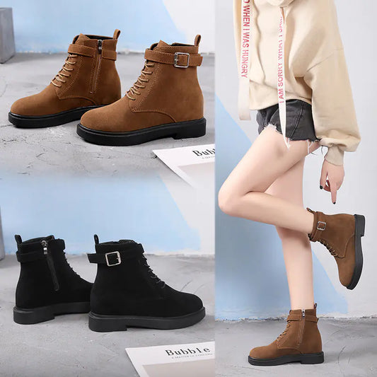 Brown and black boots shown on a concrete floor with a person wearing brown boots.